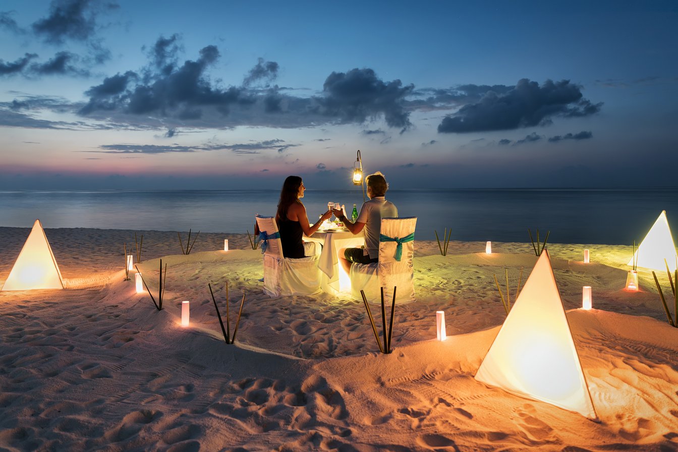 Honeymoon couple is having a private, romantic dinner